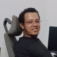 Abdullah Albaki, founder of 7CGI studio, sitting in a chair smiling .