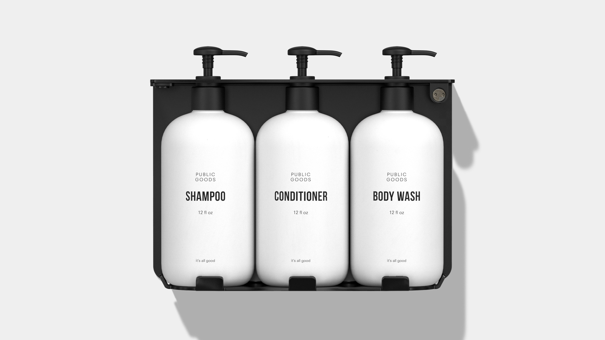 Three labeled wall mounted bottles on a dispenser
