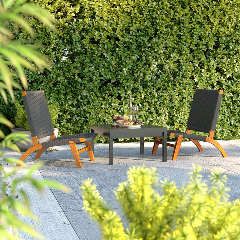 Outdoor patio setup with two lounge chairs and a square table, surrounded by lush greenery, ideal for relaxing in natural settings.